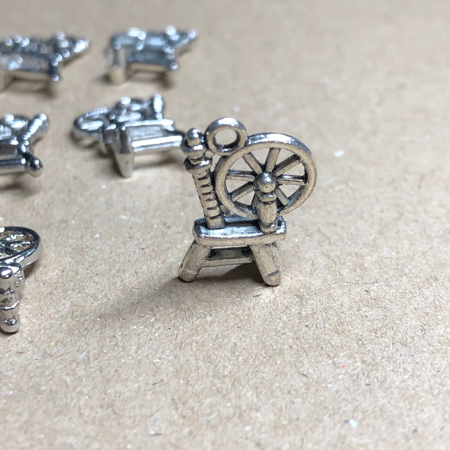 Twelve spinning wheel charms