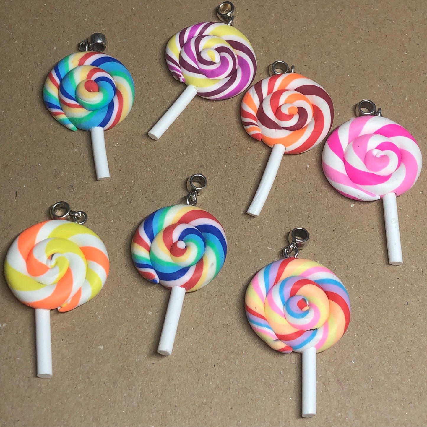 Seven rainbow Fimo lollipop pendants