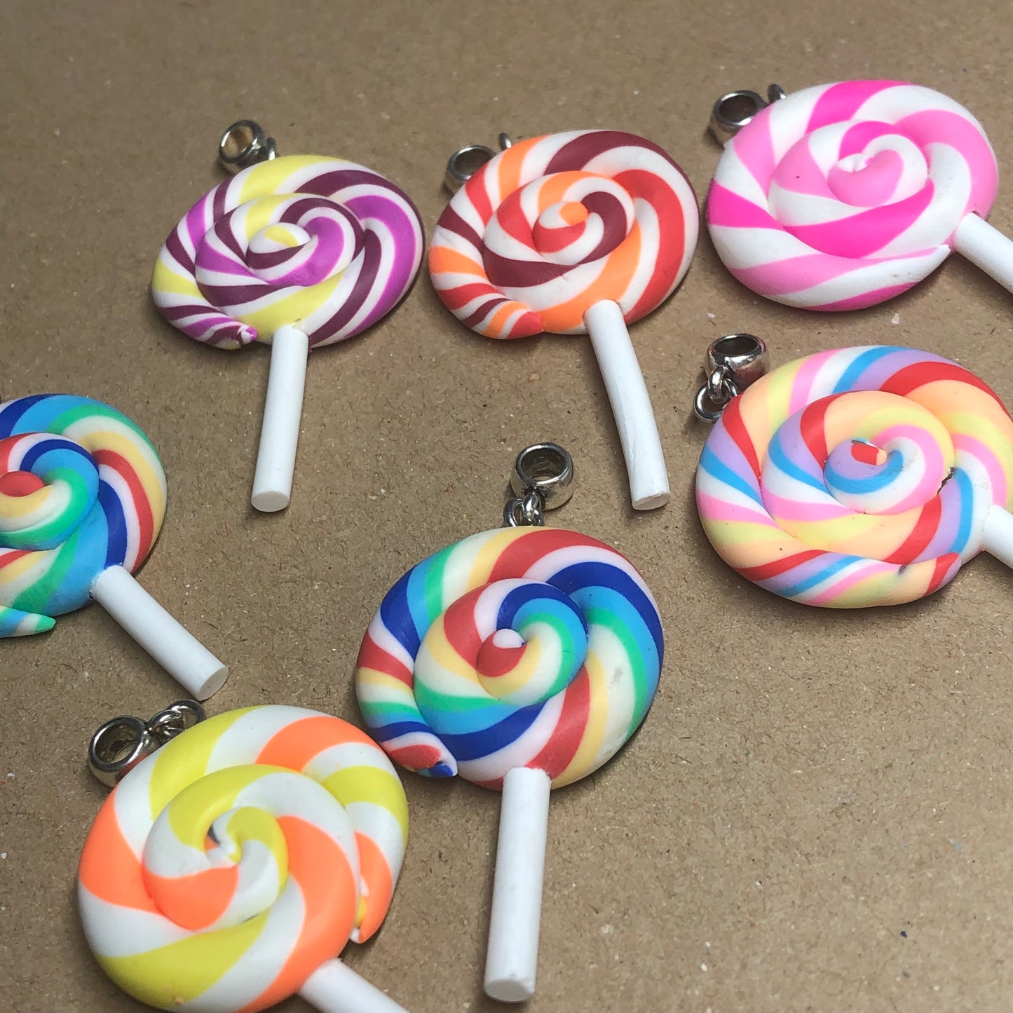 Seven rainbow Fimo lollipop pendants