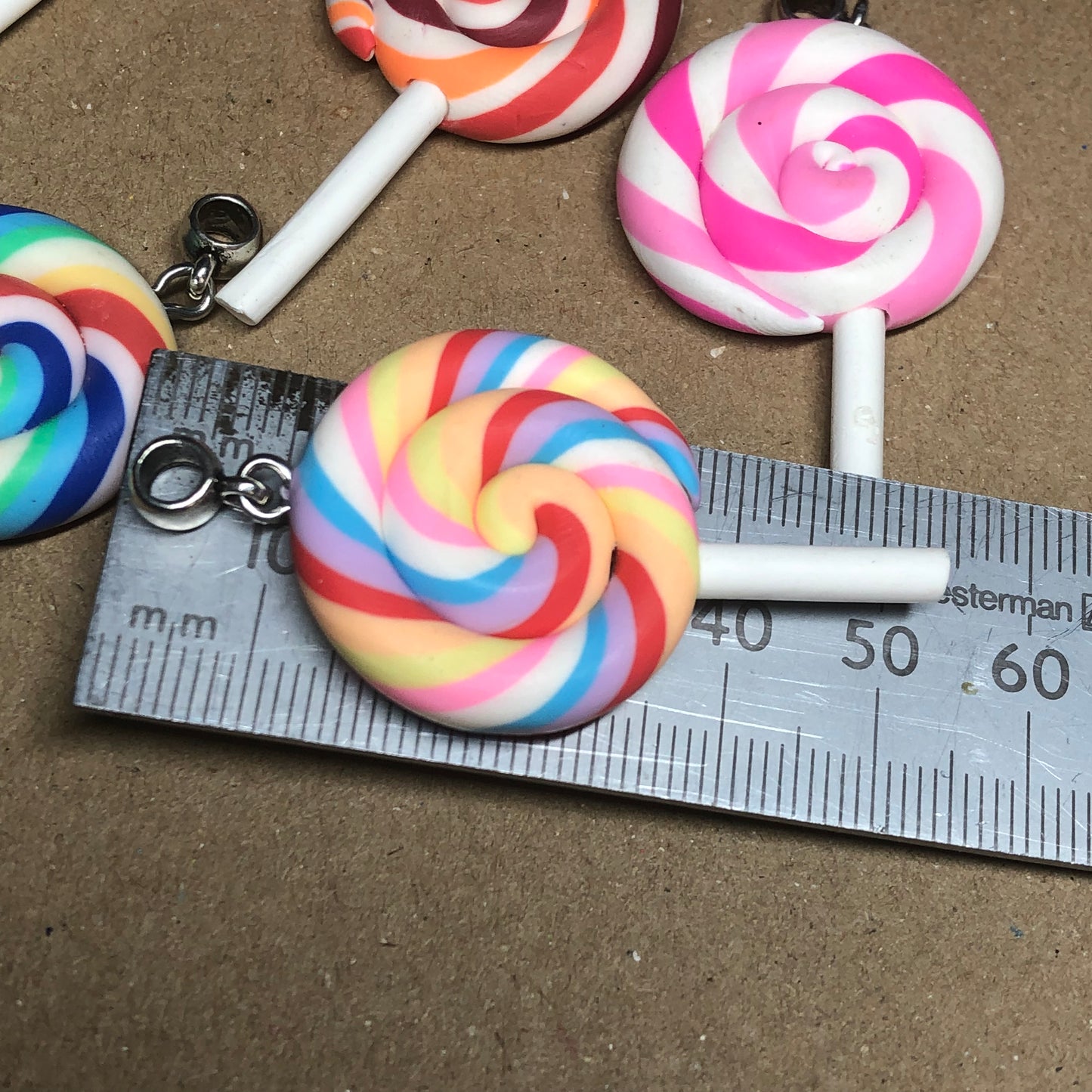 Seven rainbow Fimo lollipop pendants