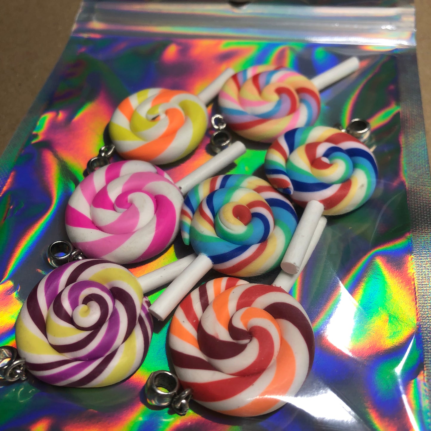 Seven rainbow Fimo lollipop pendants