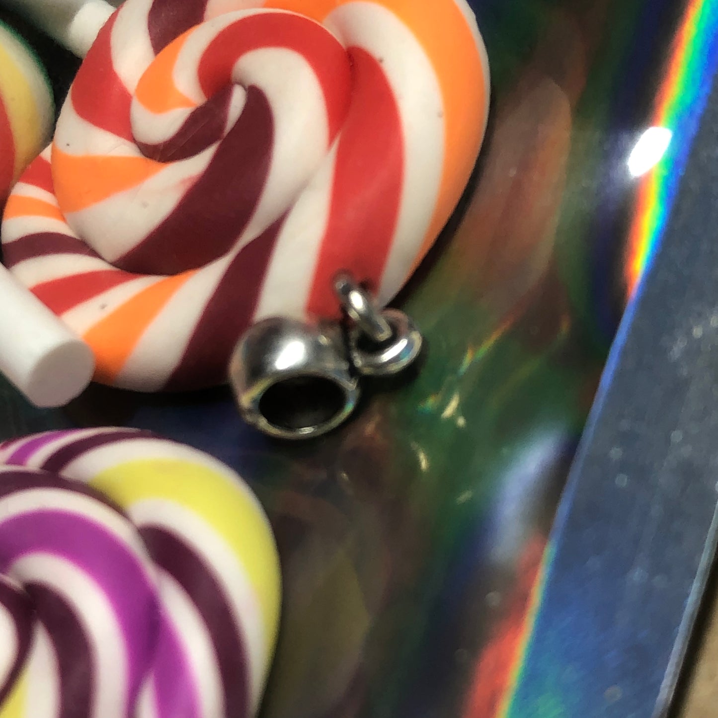 Seven rainbow Fimo lollipop pendants