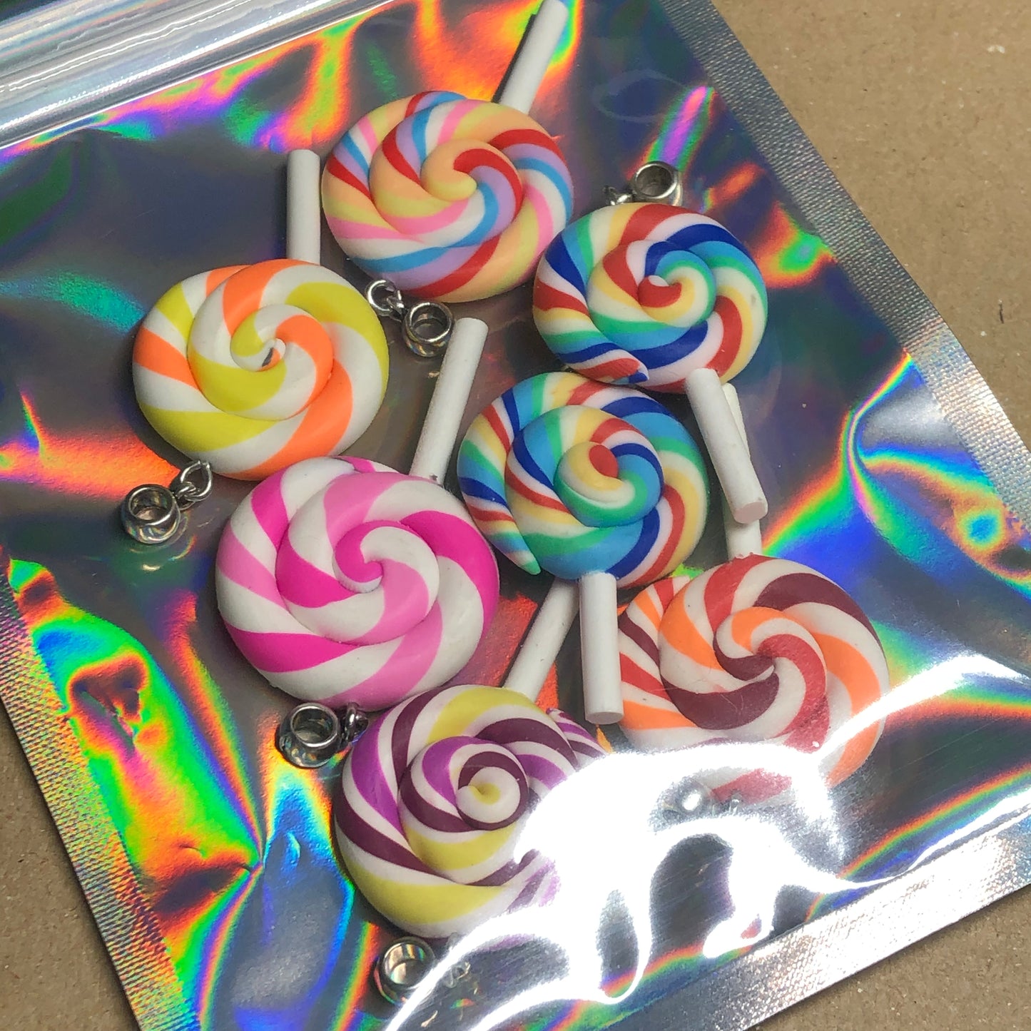 Seven rainbow Fimo lollipop pendants