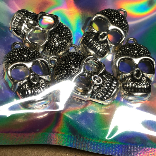 Six large skull charms