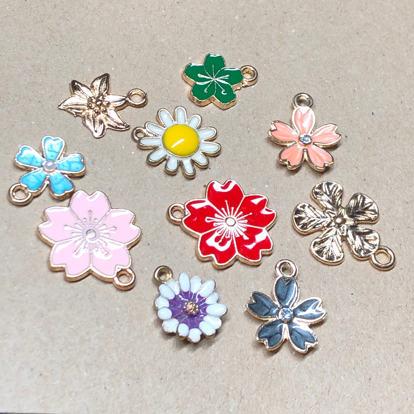 Ten gold and enamel flower charms