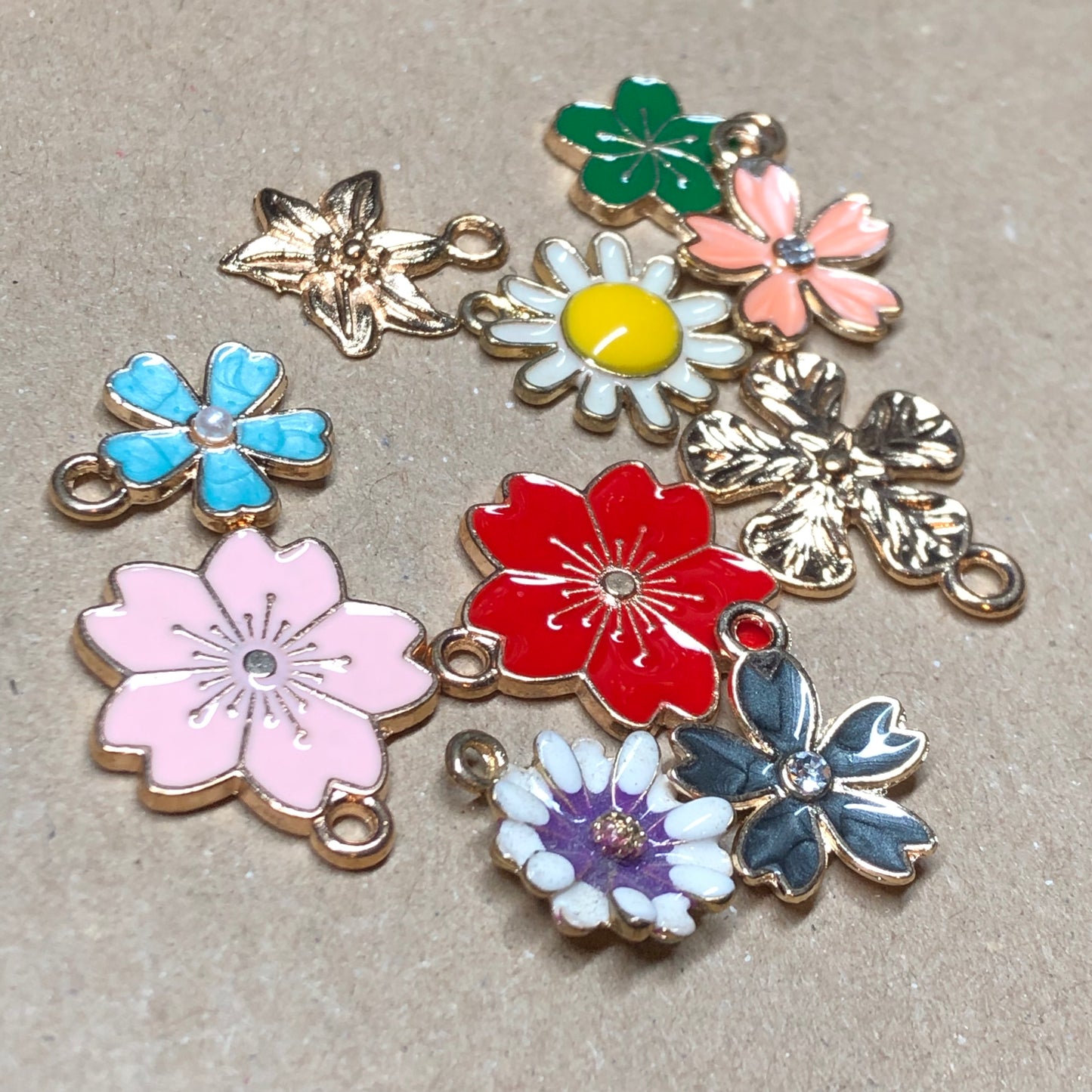 Ten gold and enamel flower charms