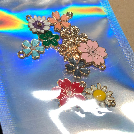 Ten gold and enamel flower charms