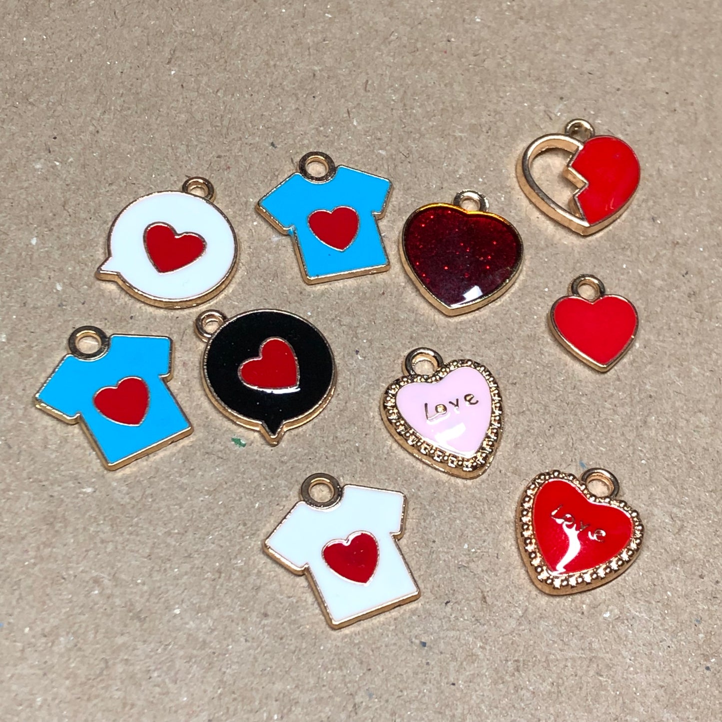 Ten gold and enamel love charms