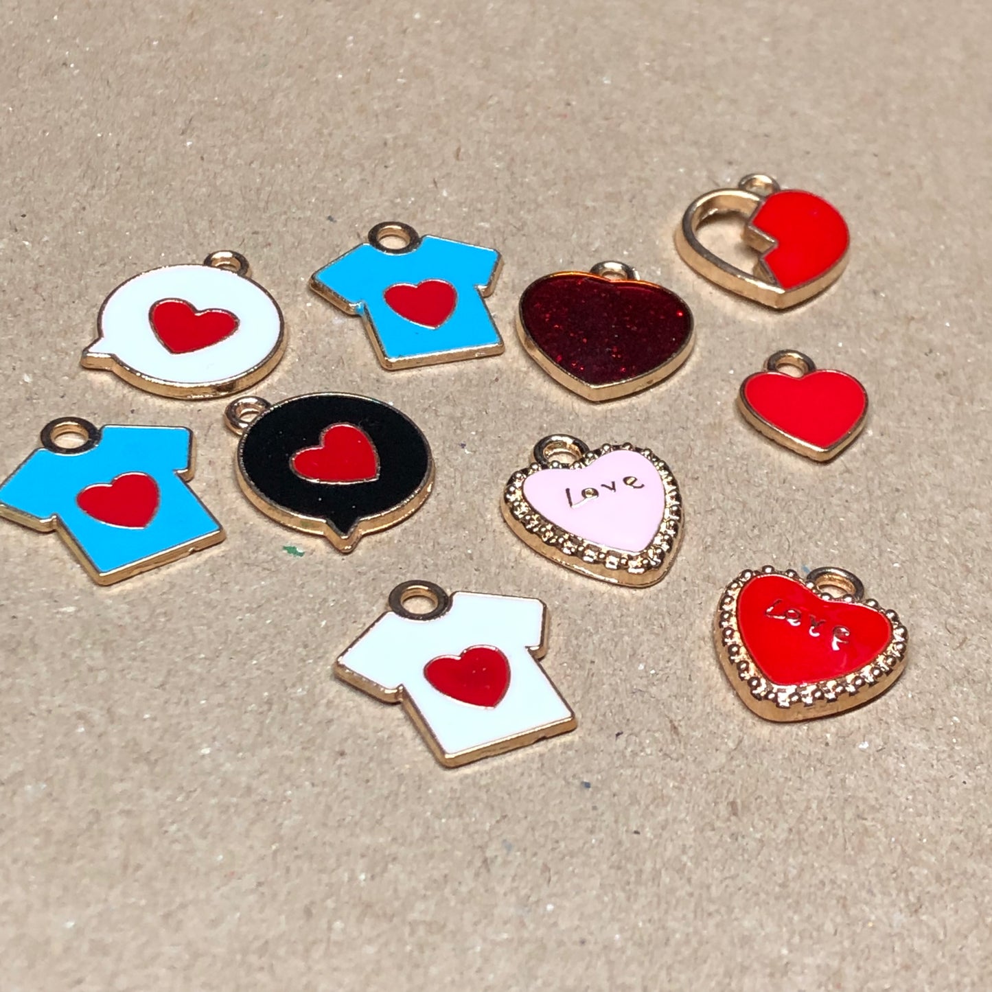 Ten gold and enamel love charms