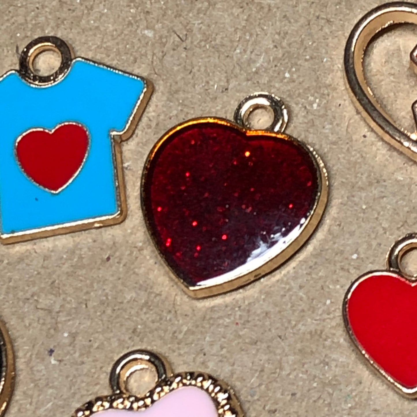 Ten gold and enamel love charms