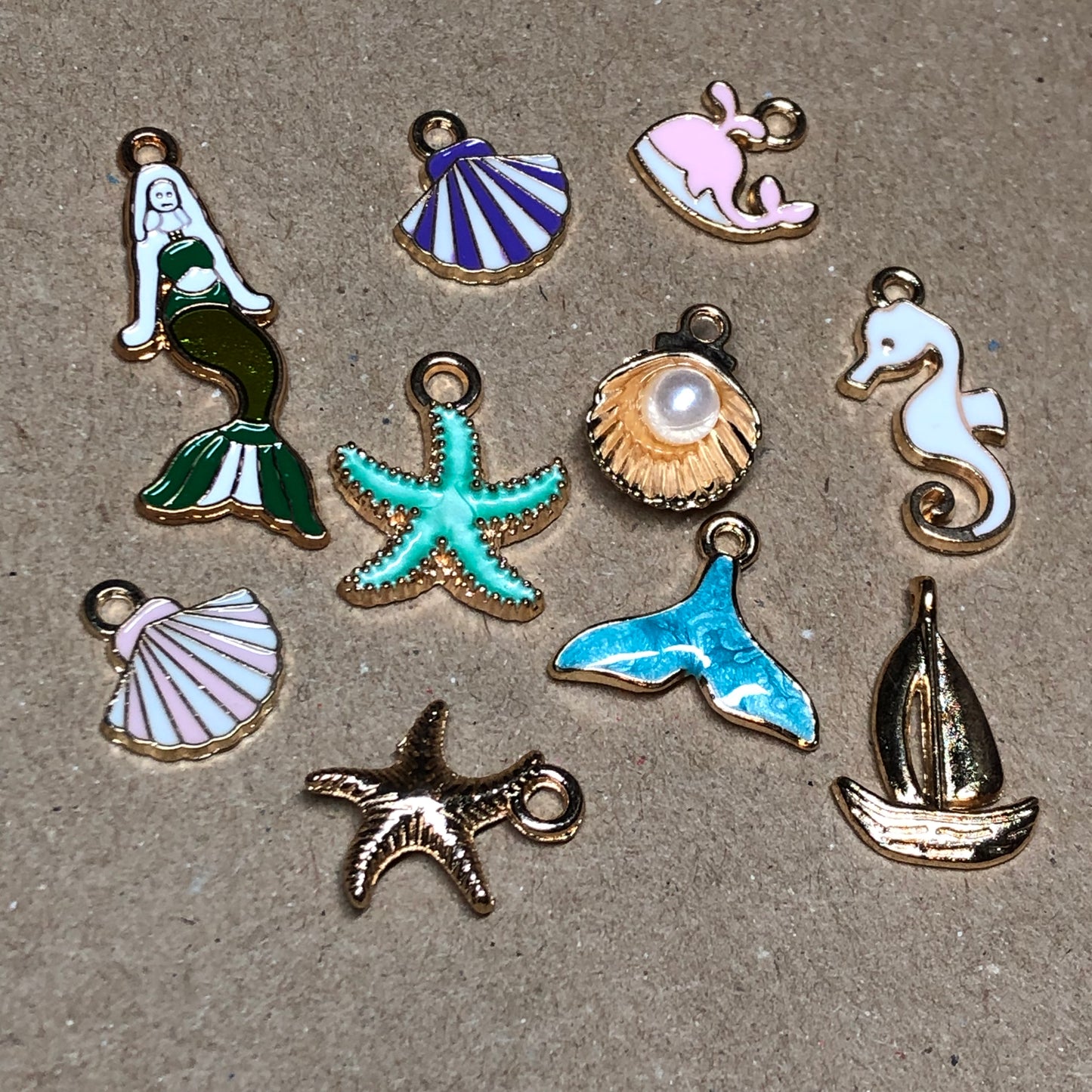 Ten gold and enamel seaside charms