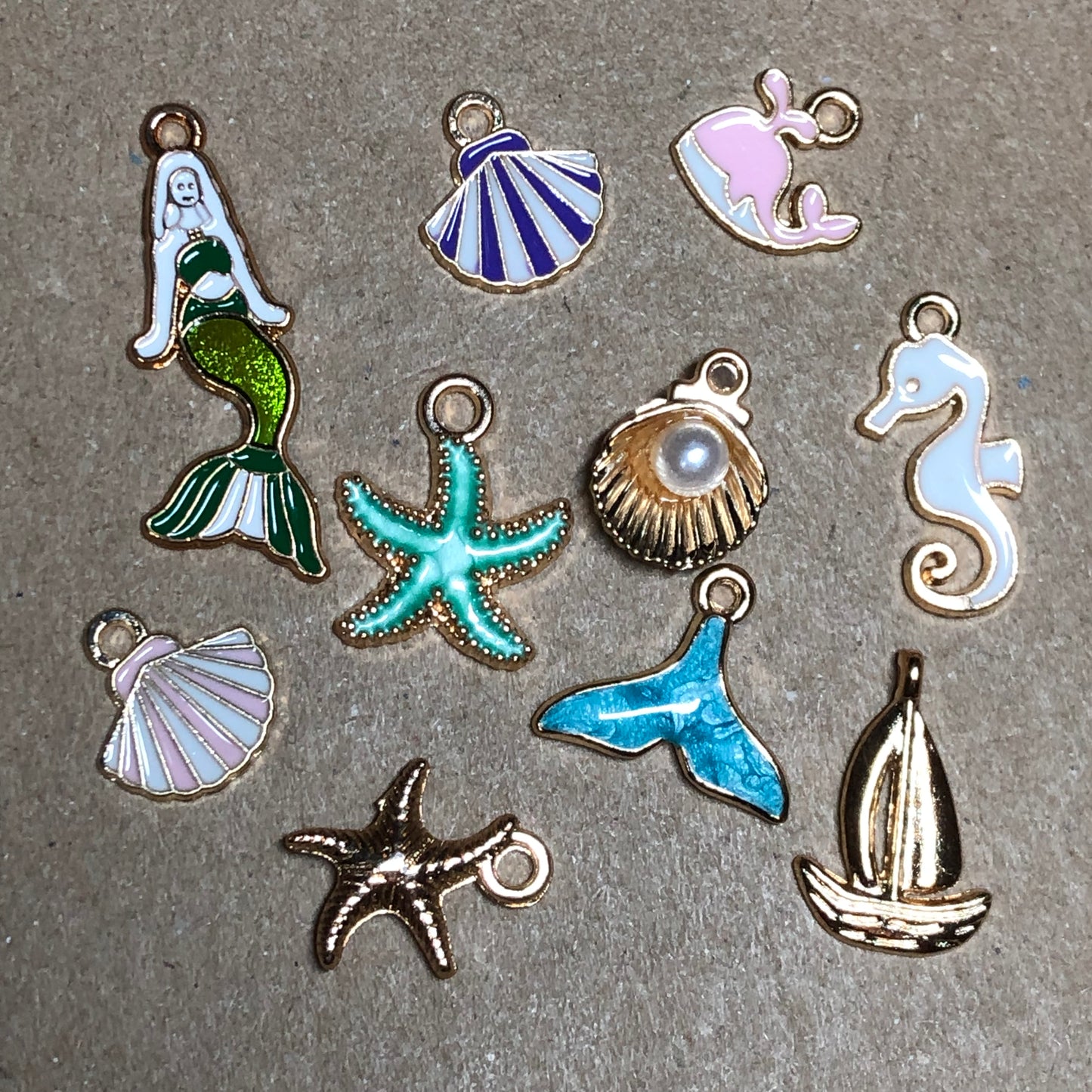 Ten gold and enamel seaside charms