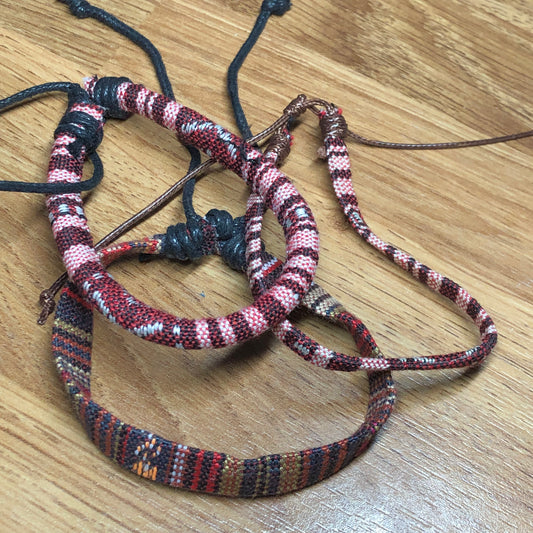 Three brown handmade Bohemian cord braided woven stackable bracelets