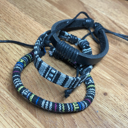 Three monochrome handmade Bohemian cord braided woven stackable bracelets