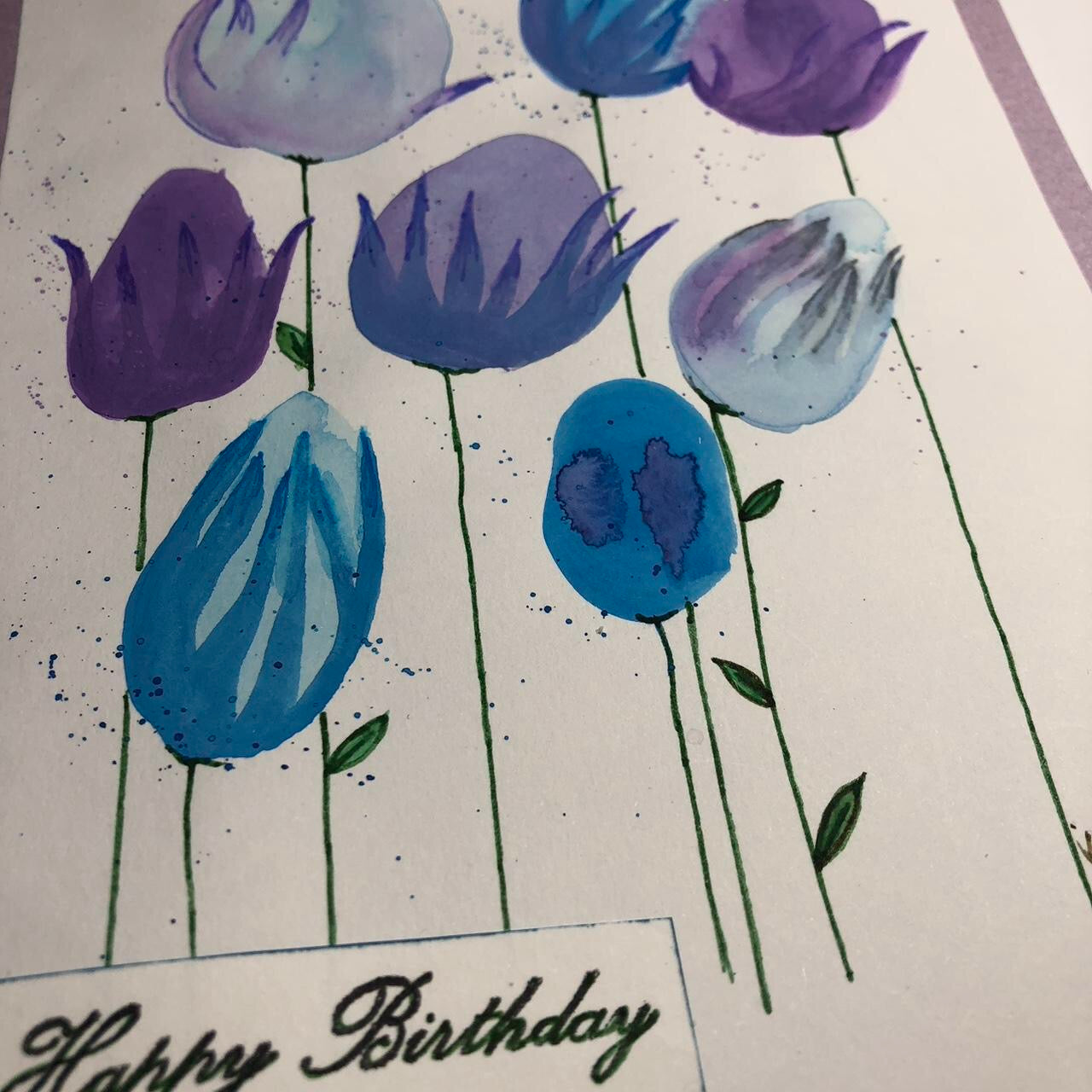 Rounded blue and purple flower watercolour birthday card