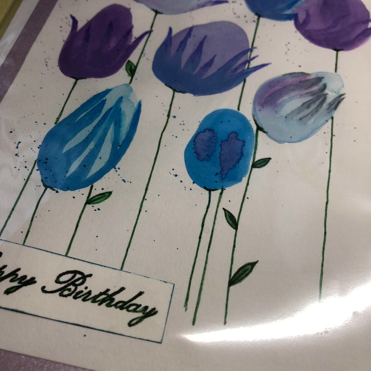 Rounded blue and purple flower watercolour birthday card