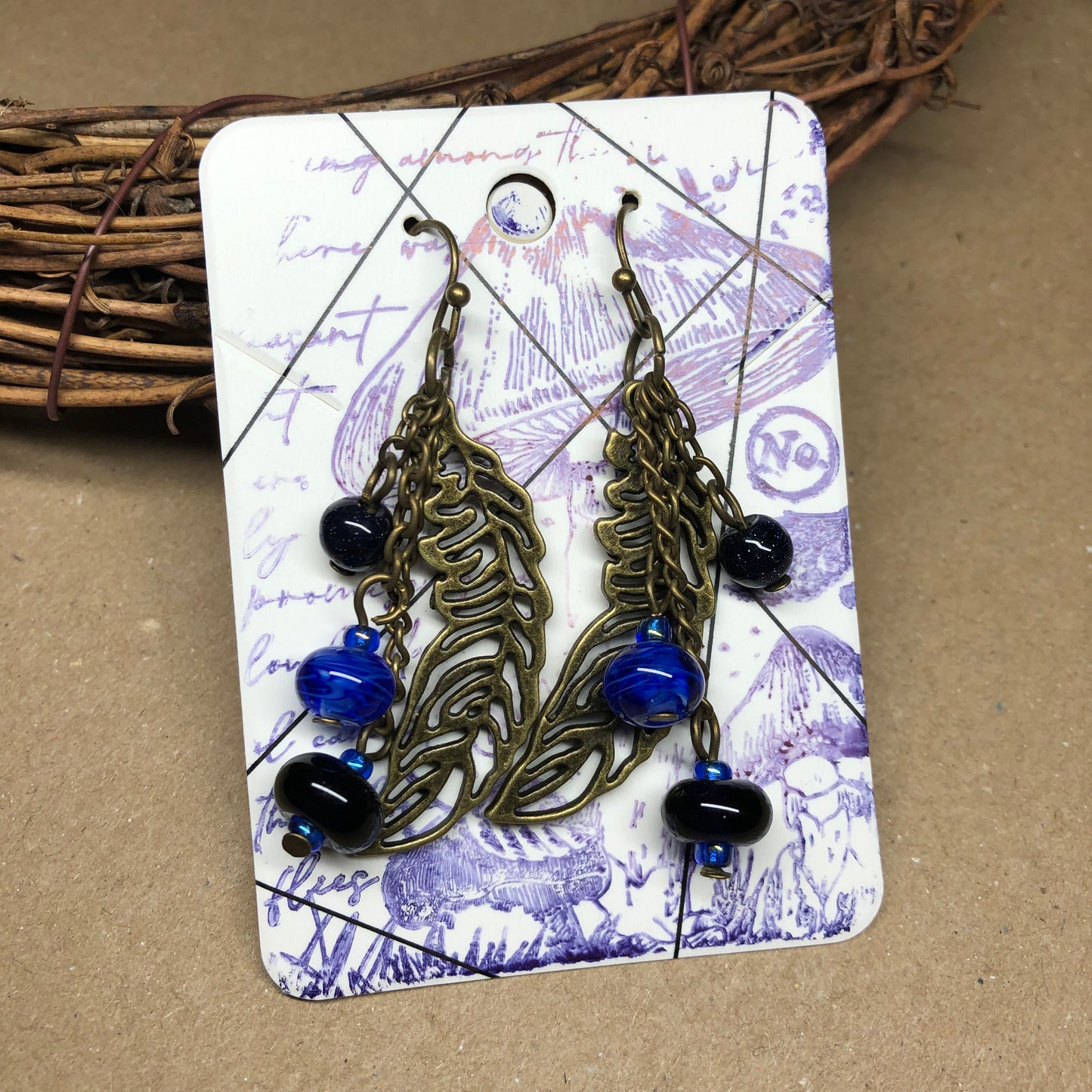 Goldstone and artisan glass feather earrings