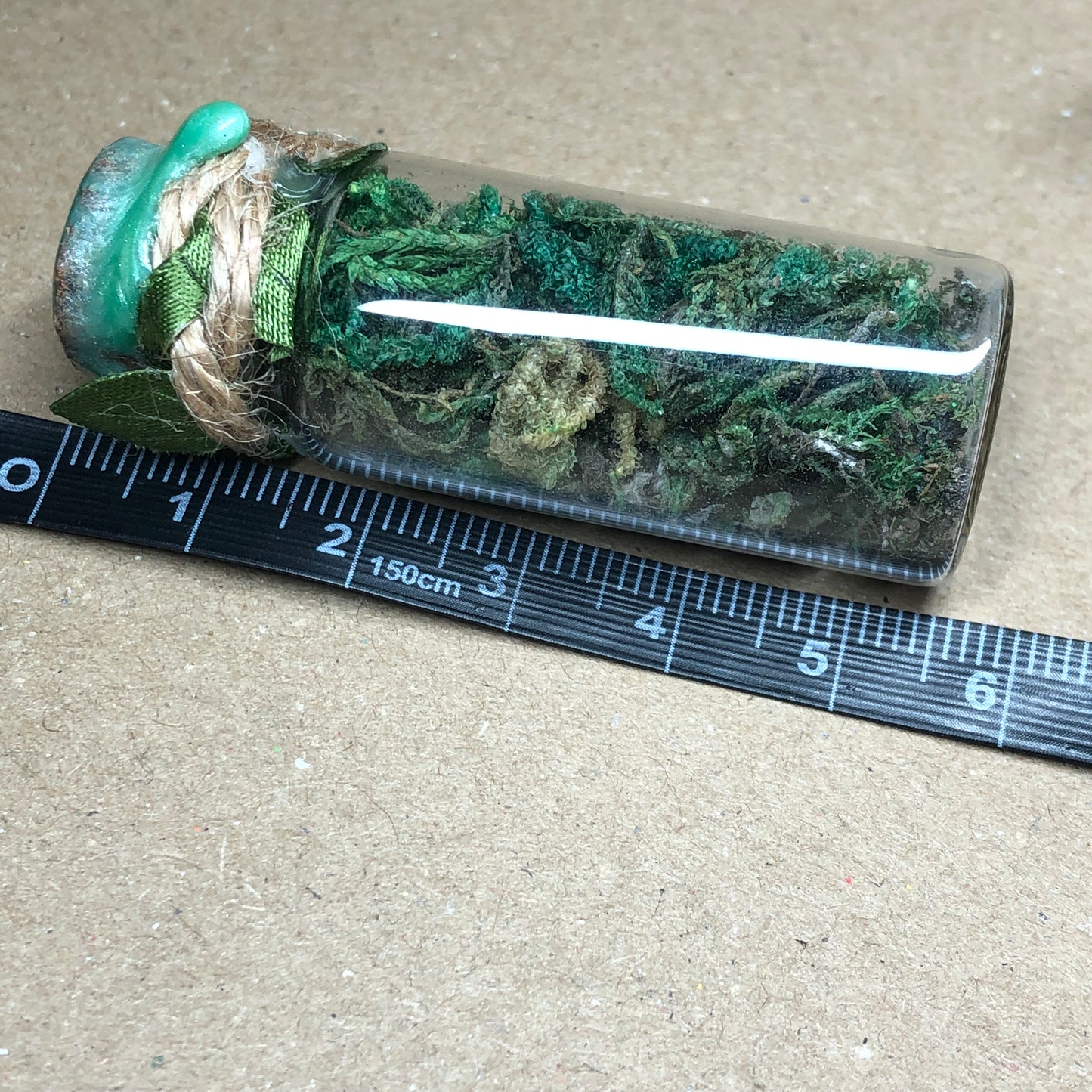 Moss filled decorative apothecary bottle