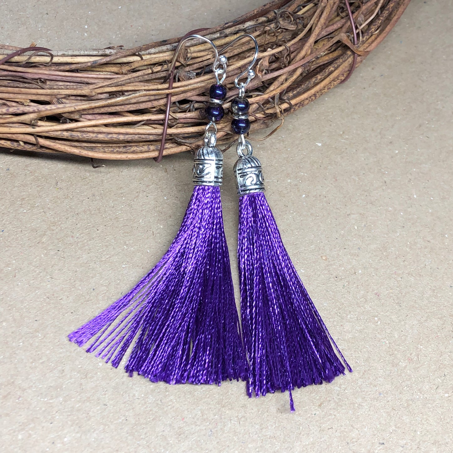 Purple tassel earrings with glass beads