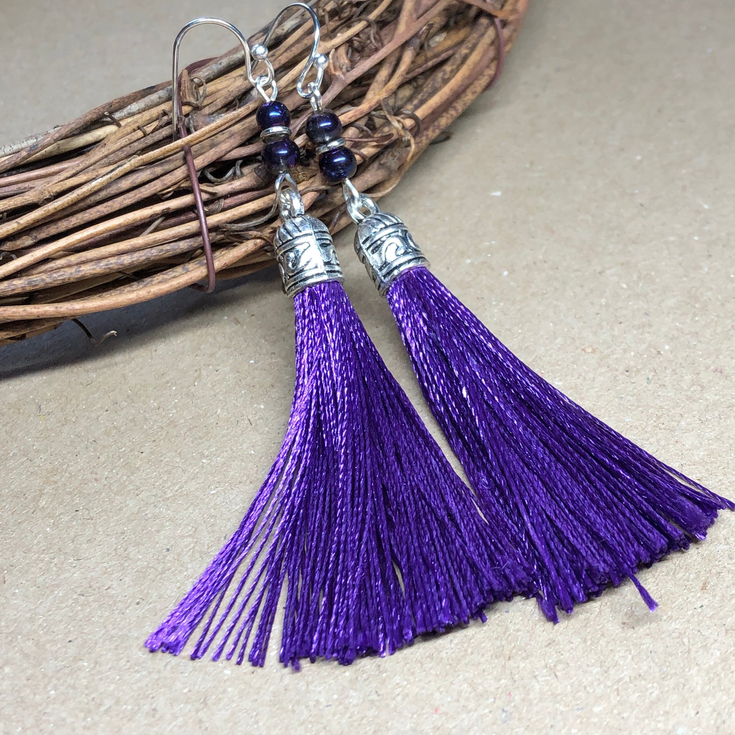 Purple tassel earrings with glass beads