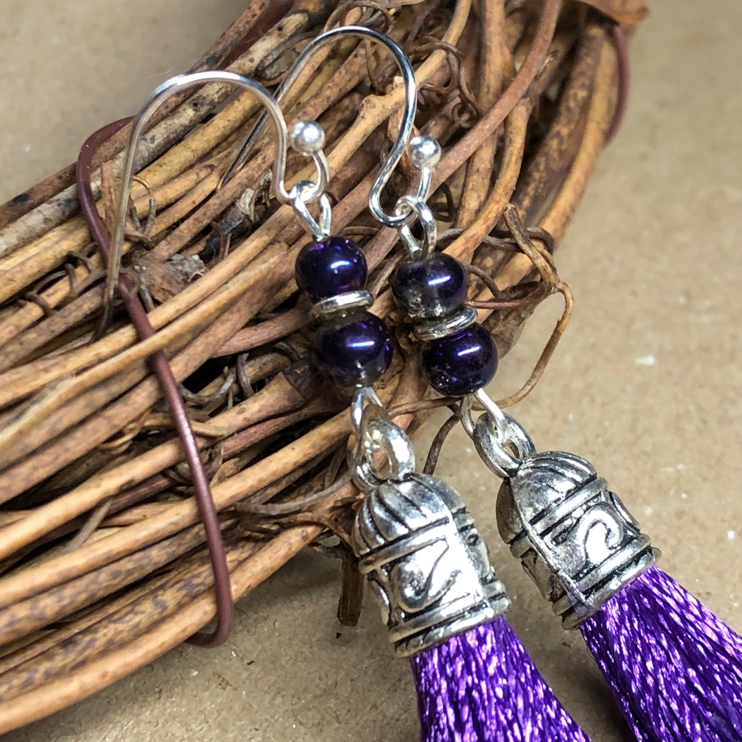 Purple tassel earrings with glass beads