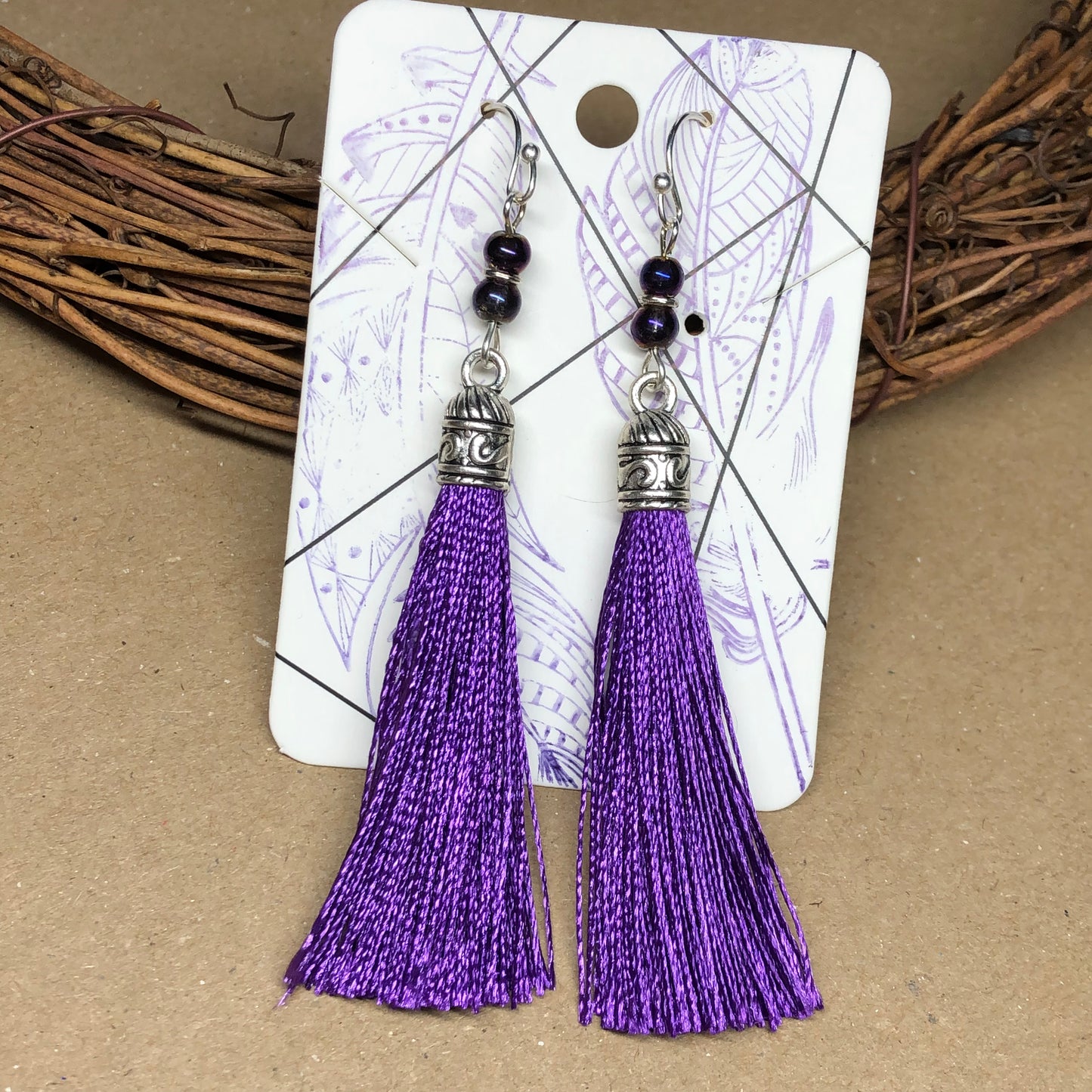 Purple tassel earrings with glass beads