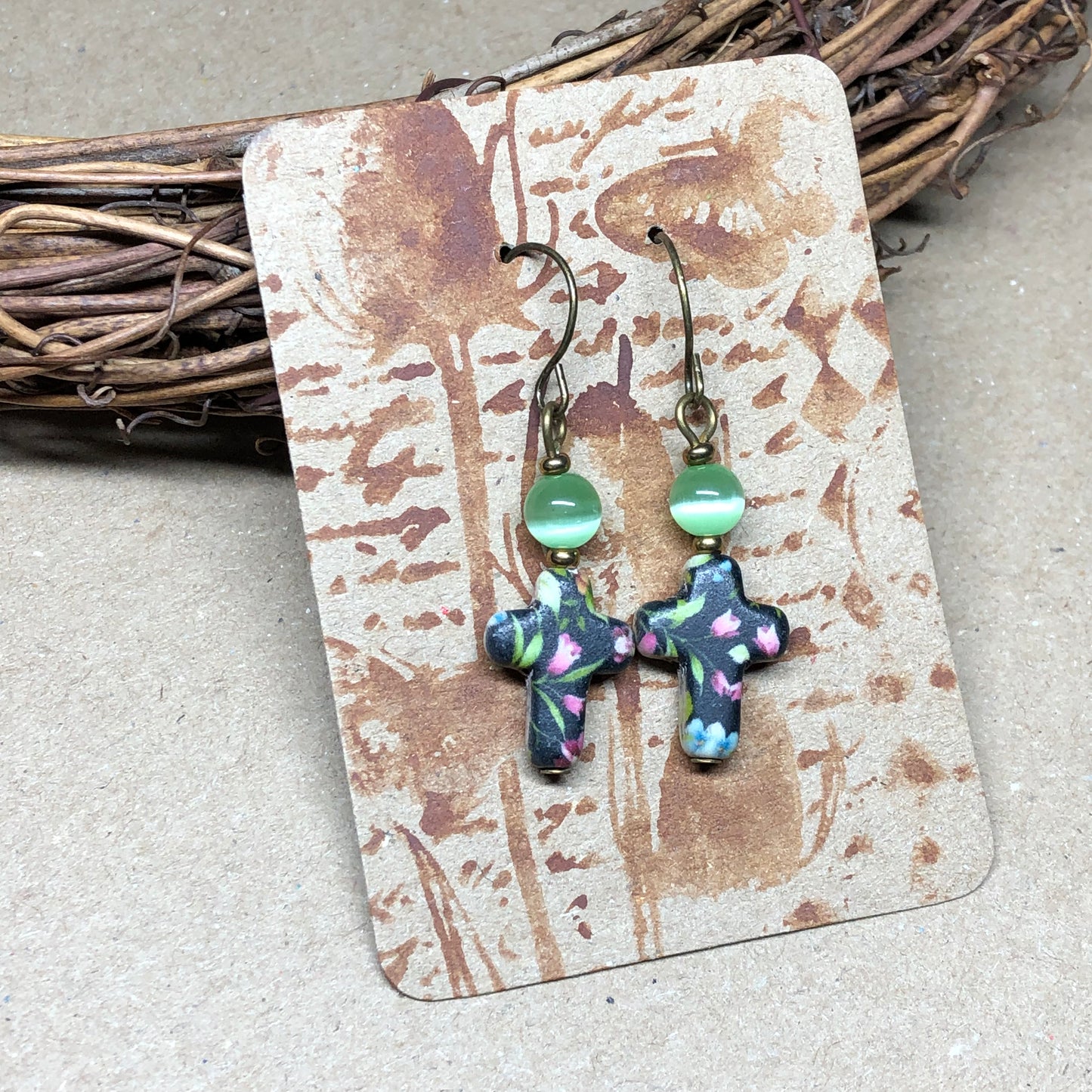 Green cats eye floral cross earrings