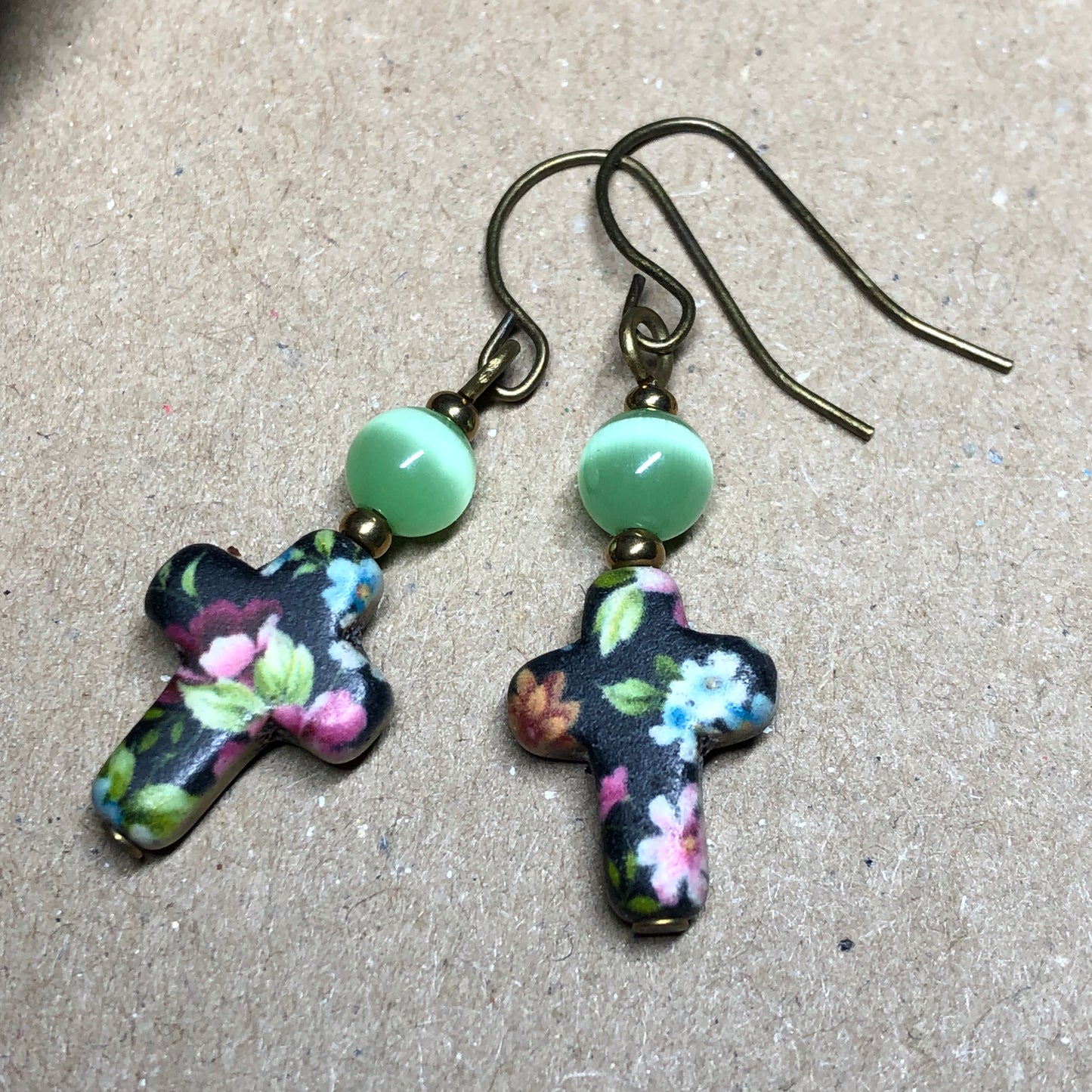 Green cats eye floral cross earrings