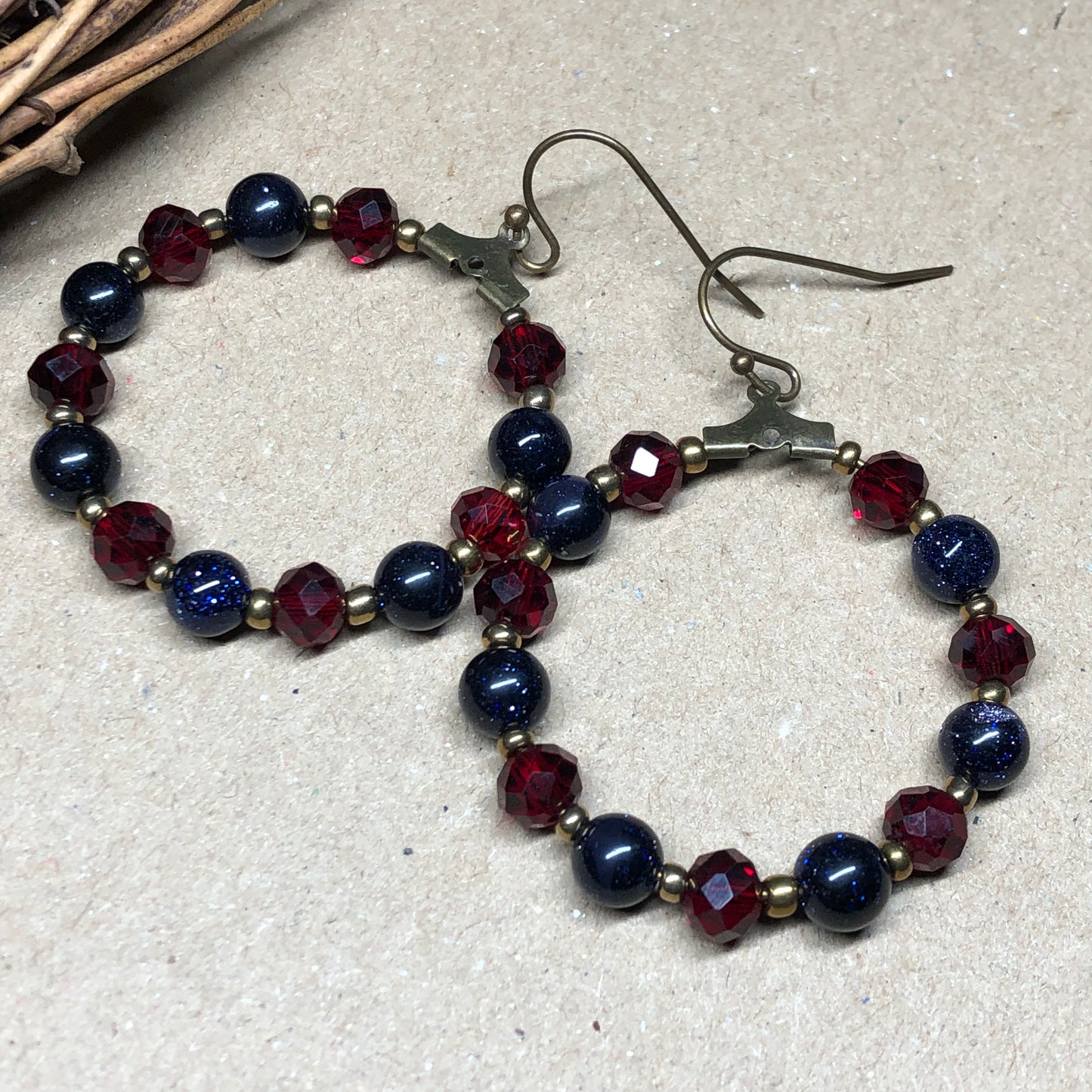 Goldstone and red crystal hoop earrings