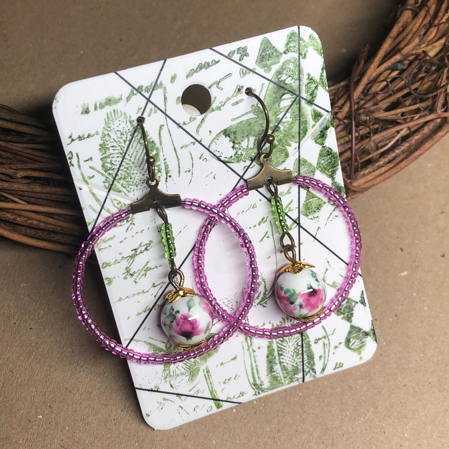 Pink glass hoop earrings with floral porcelain beads