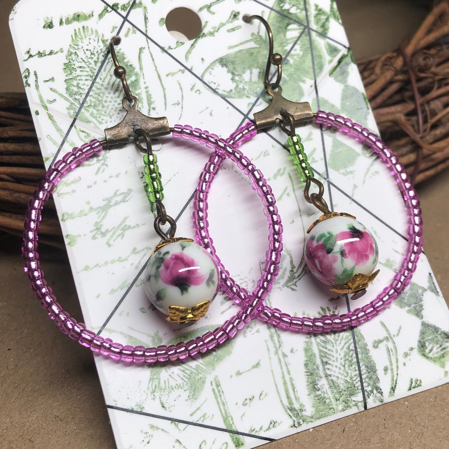 Pink glass hoop earrings with floral porcelain beads