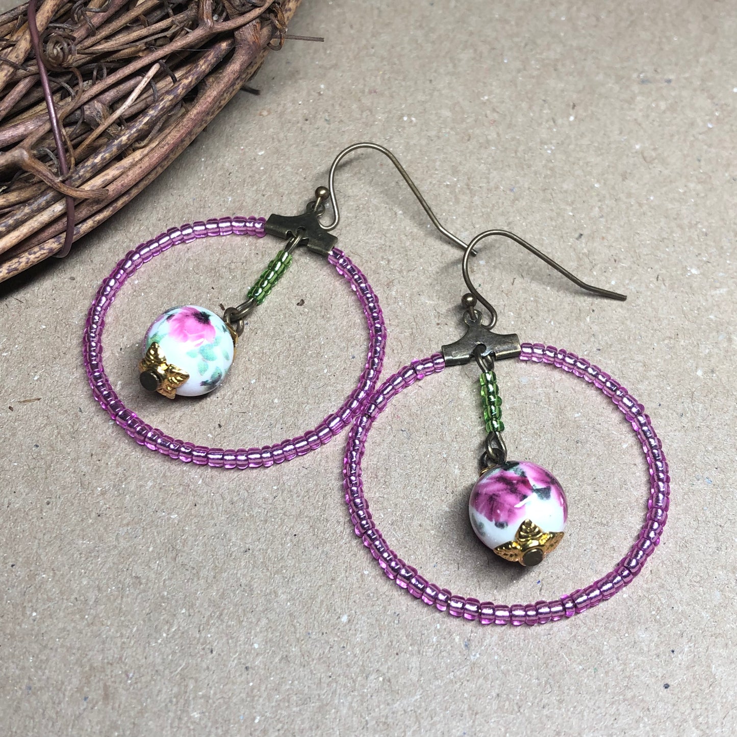 Pink glass hoop earrings with floral porcelain beads