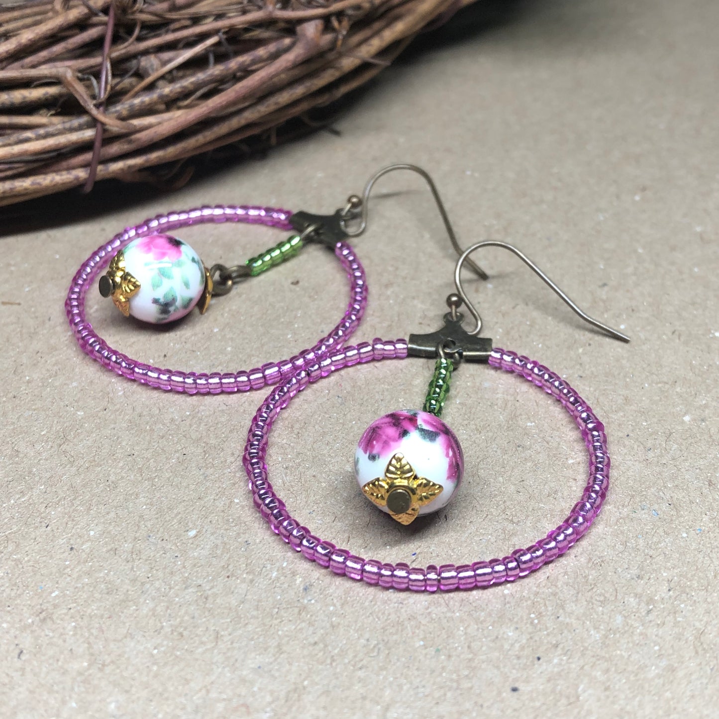 Pink glass hoop earrings with floral porcelain beads