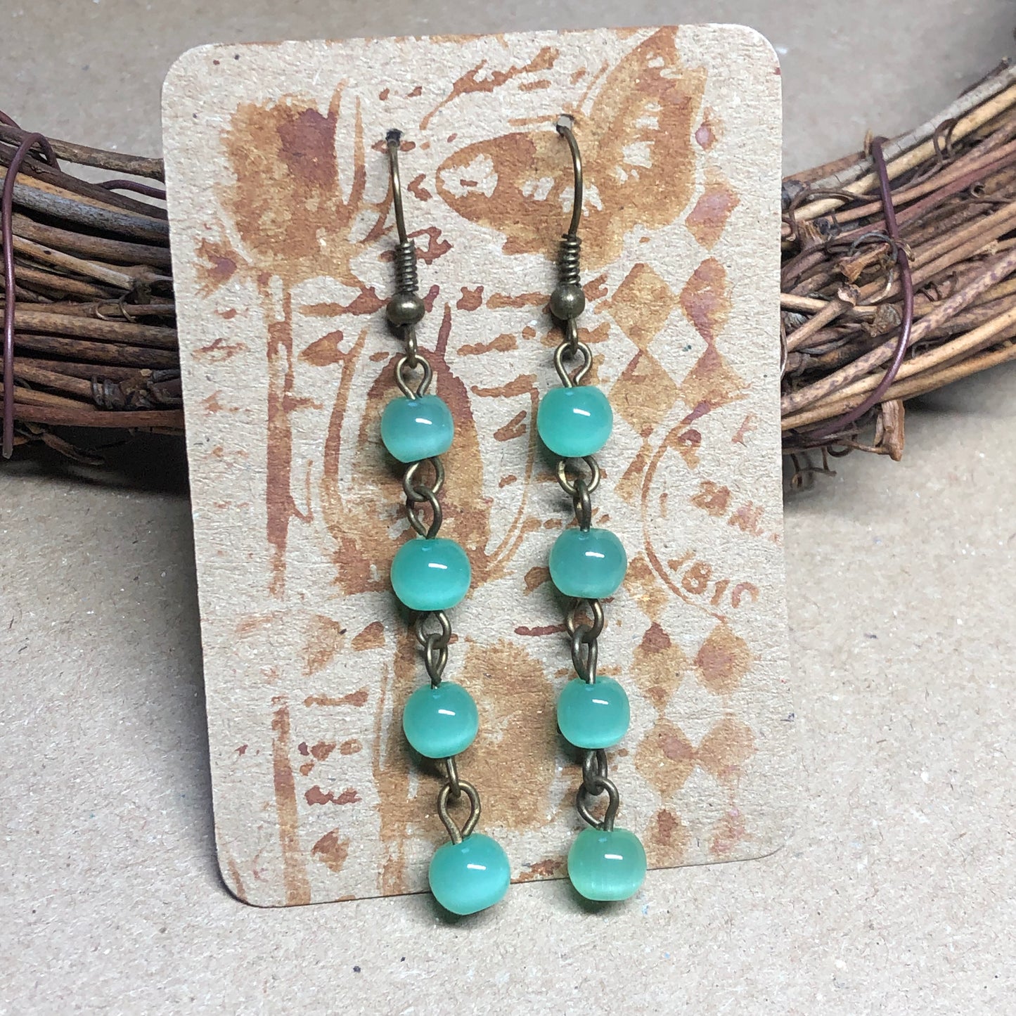 Green glass cats eye earrings