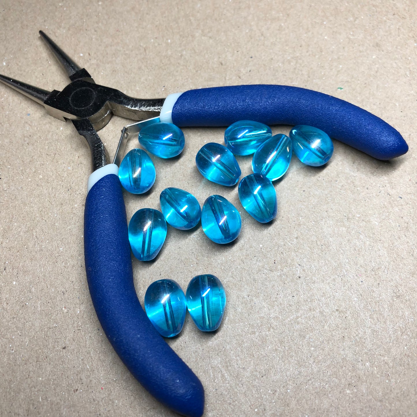 Iridescent blue teardrop shaped glass beads